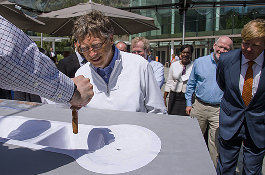Bill Gates examining an invention at the Reinvent the Toilet Fair